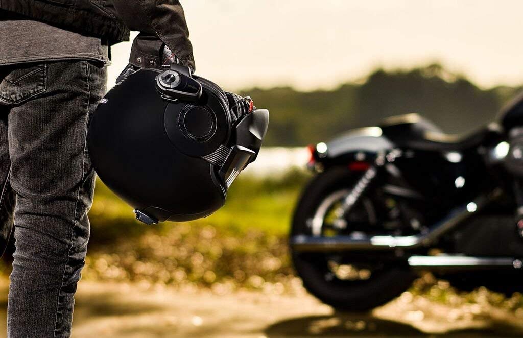 rider using Sena 10S Bluetooth communication system for calls, GPS, and music during ride